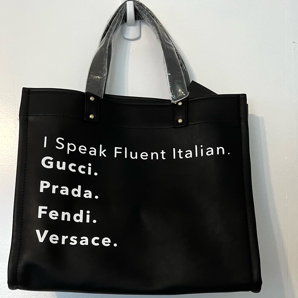 black tote bag with zipper closure, inside pockets, extra strap, vegan leather